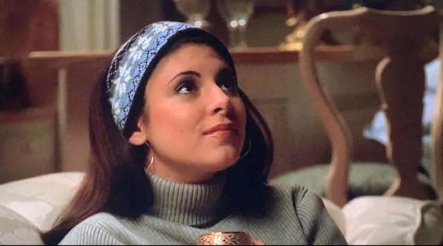 meadow soprano is sitting in her house looking up at her christmas tree.