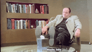 Tony Soprano sitting with his feet up on the table in Dr. Melfi's office.